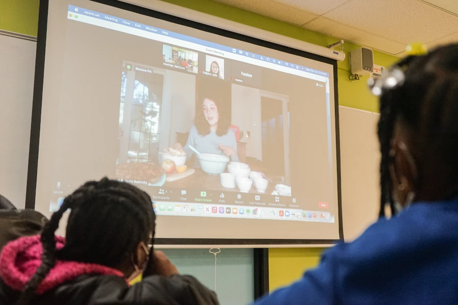 kids watching a presentation on a classroom projector screen